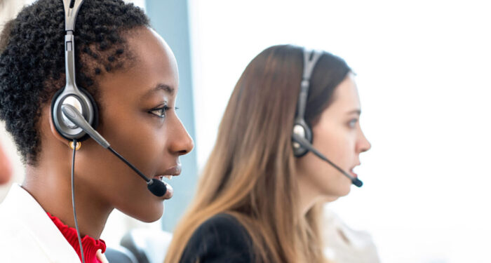 Group of diverse telemarketing customer service staff team in call center banner background