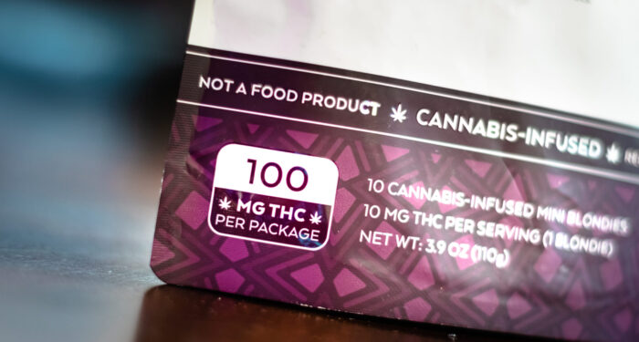 100mg THC dosage warning for a cannabis plant infused edible. Up close on packaging.