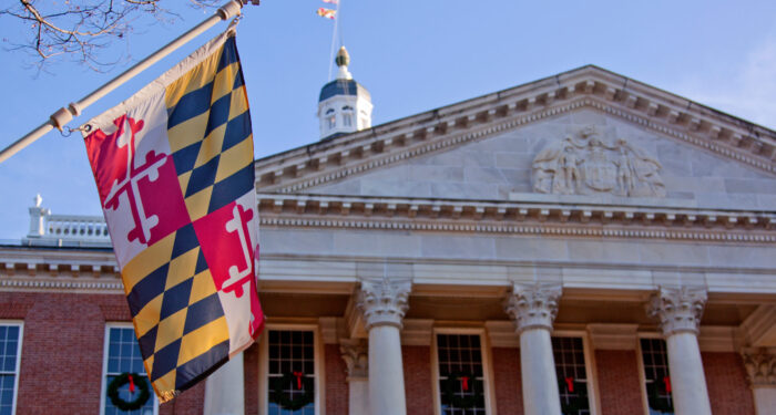 Close up view of Maryland state flag in front of the capitol state house in Annapolis, MD.