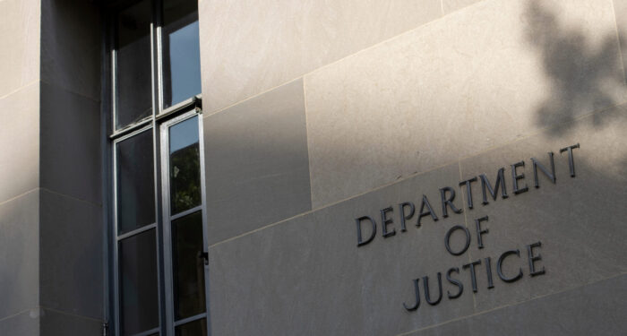 Washington, DC, USA - June 21, 2022: Closeup of the sign seen the wall outside the Robert F. Kennedy Building, the headquarters of the U.S. Department of Justice (DOJ) in Washington, DC.