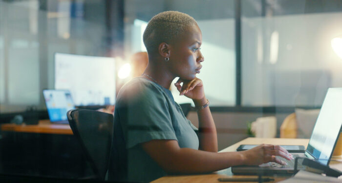 Business, office laptop or black woman typing feedback review of finance portfolio, stock market or investment. Coworking space, forex account manager or profile trader trading NFT, bitcoin or crypto.