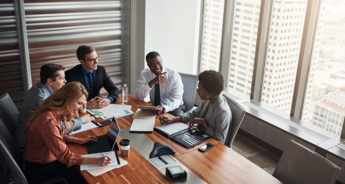 Business people, group and meeting with data analytics for financial report, solution or collaboration on tech. Accounting analyst or team talking of graphs, results or digital statistics in Seattle.