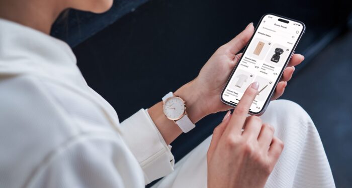 Online Shopping Experience: Woman Browsing Fashion App on Smartphone