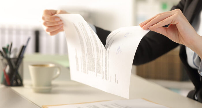 Business woman hands tearing document at the office